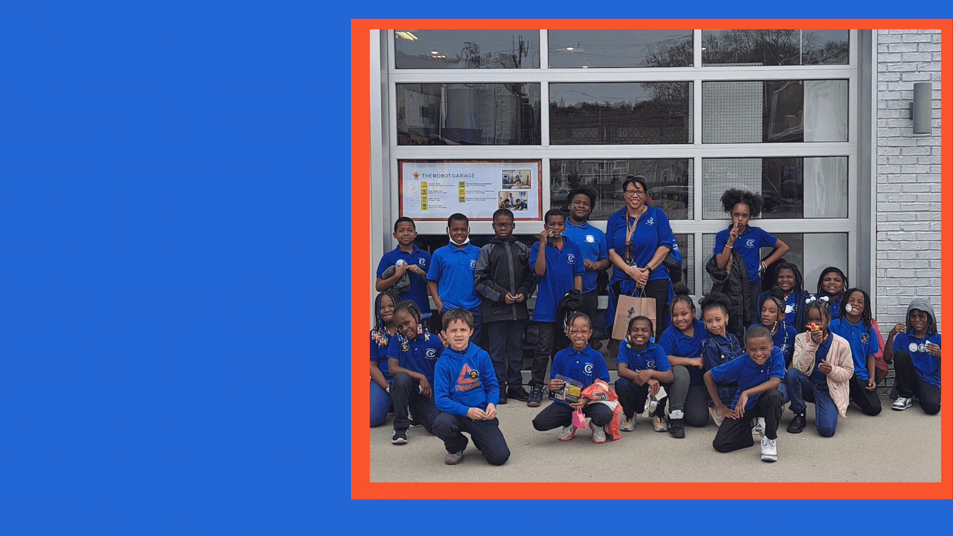  picture of students with teacher in front of The Robot Garage